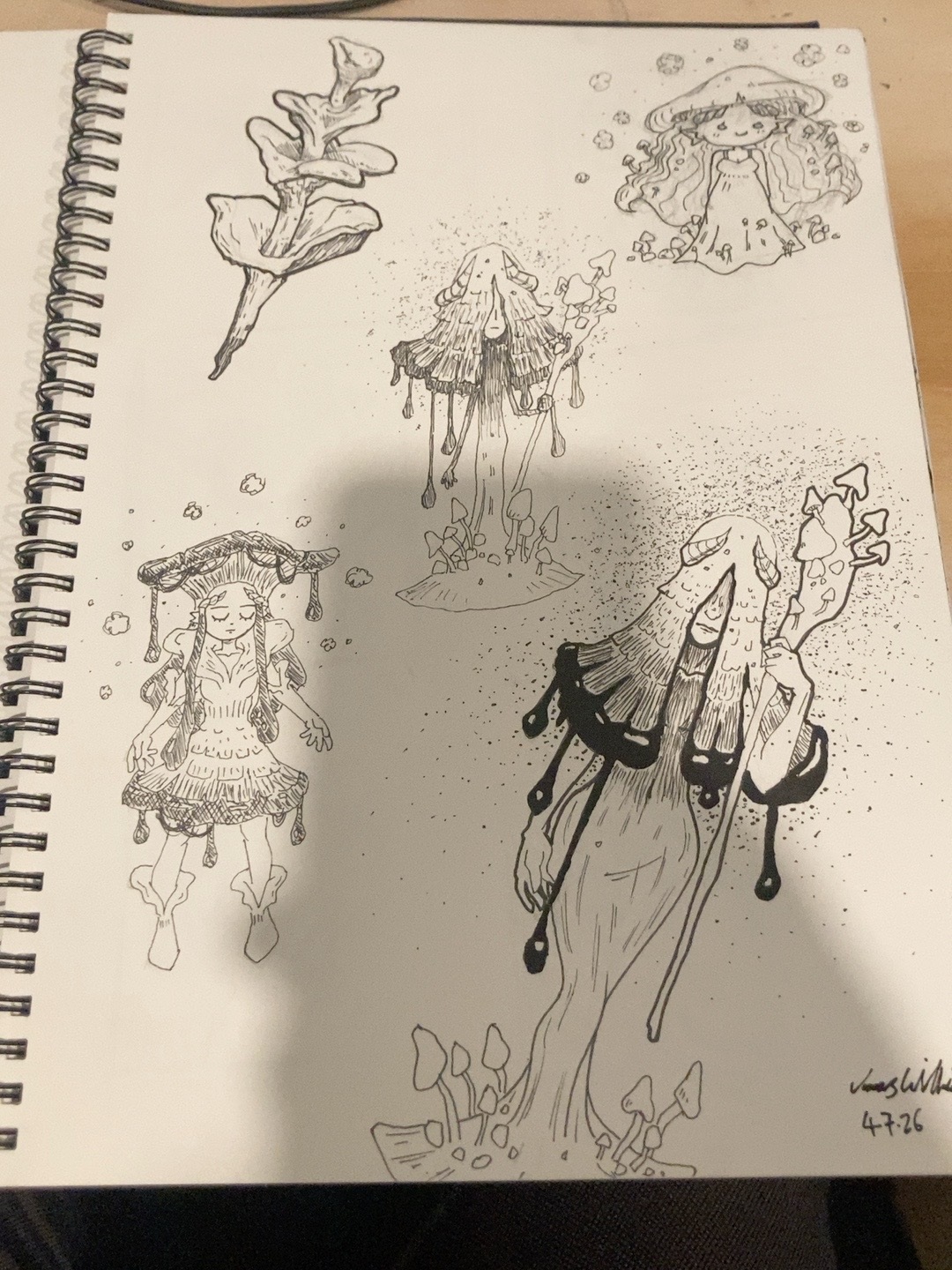 Sketchbook page of mushroom-inspired fairy characters with caps, spores, and leafy details